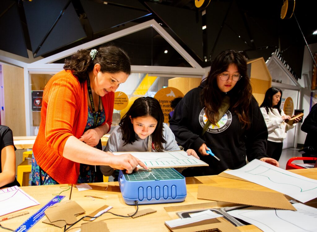 Maker Studio attendees cutting cardboard